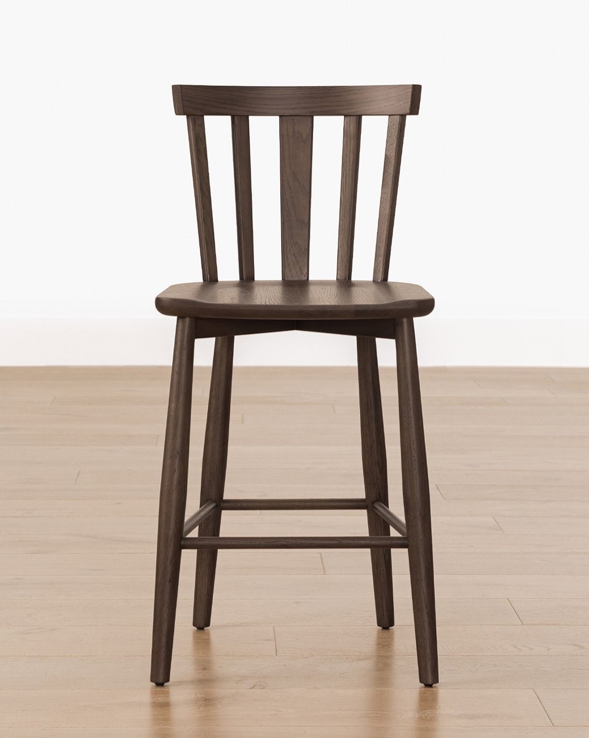 A dark solid chair design, this Hemingway stool is great for kitchen counters with vertical slats and foot rest from Studio McGee.