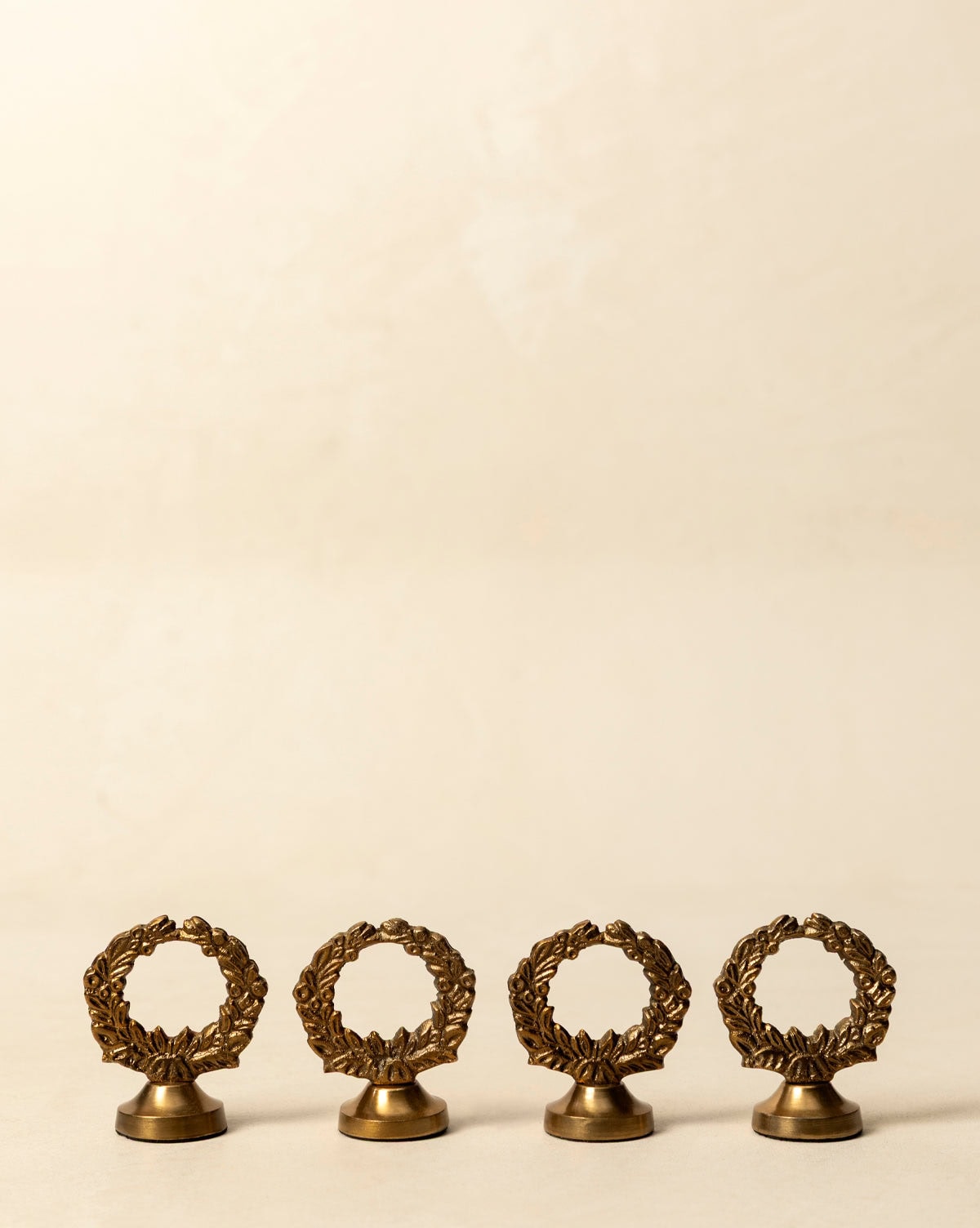 Classic wreath design tabletop guest place card holders finished in antique brass seen on Studio McGee.