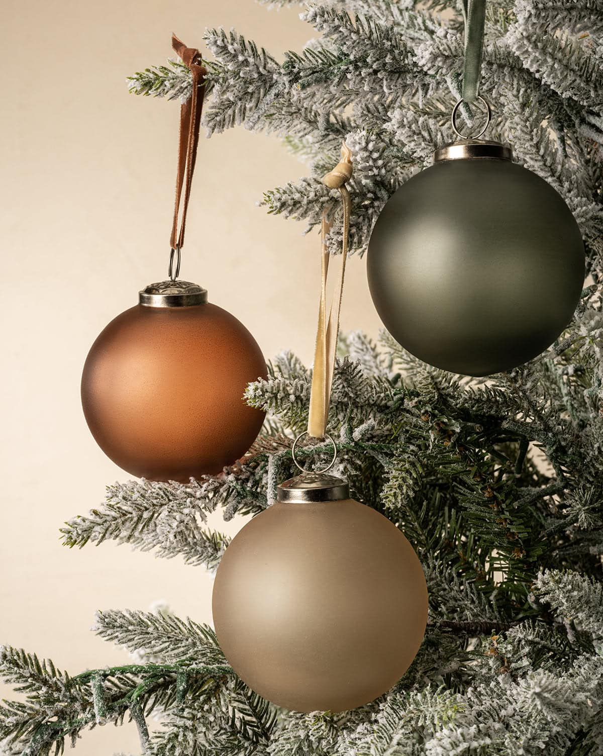 Beautiful matte finish festive ornament bulbs shown in brown, green, and gold glass, come in a set of 9 from Studio McGee.