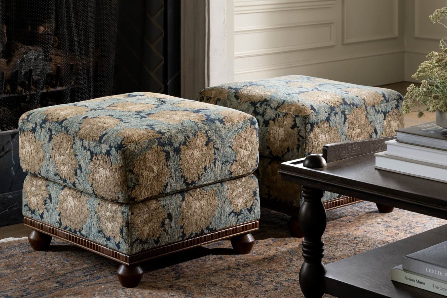 Custom tapestry ottomans in front of living room fireplace and next to wood coffee table from Studio McGee Winter.