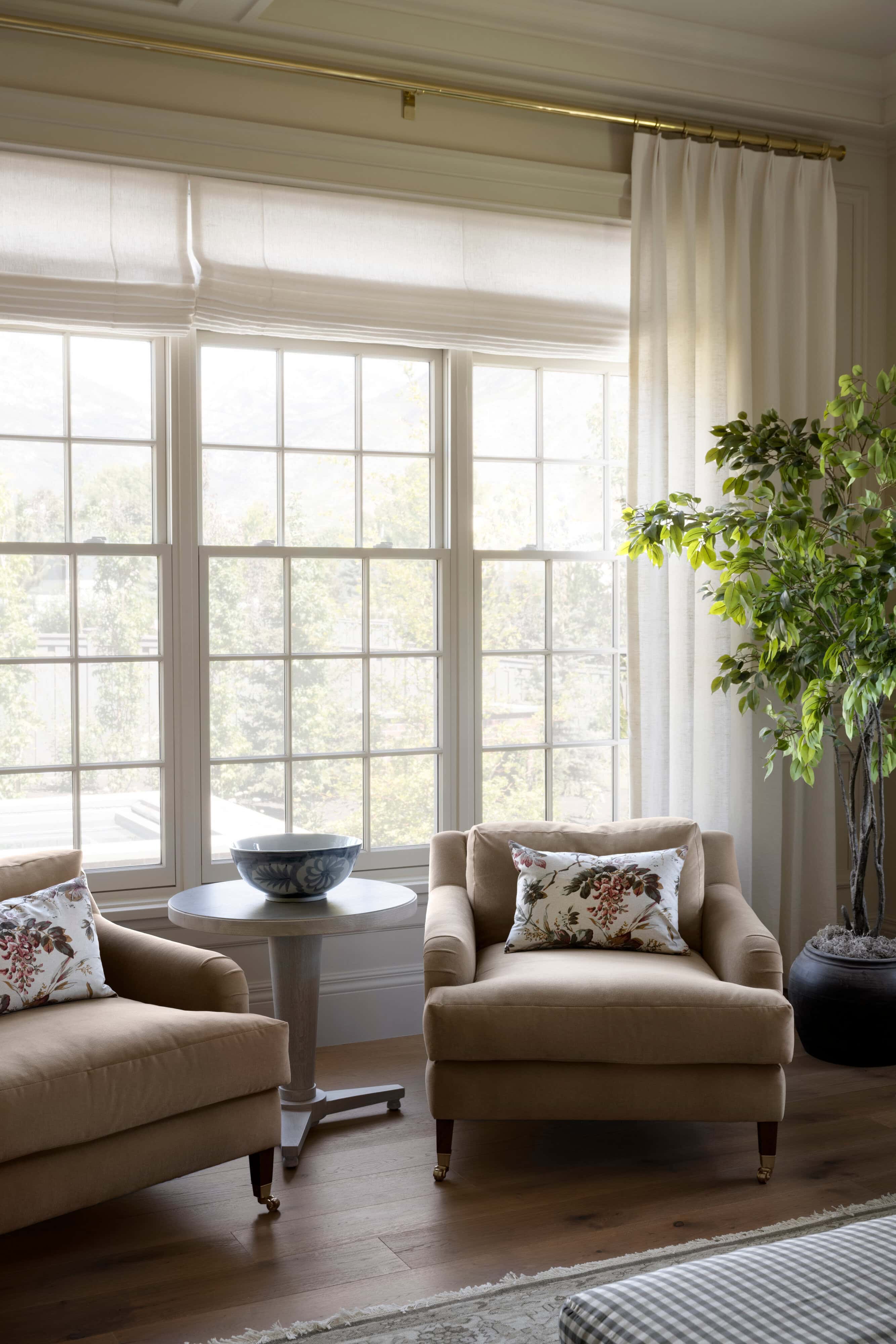 A living room with chairs and a plant, by McGee & Co.