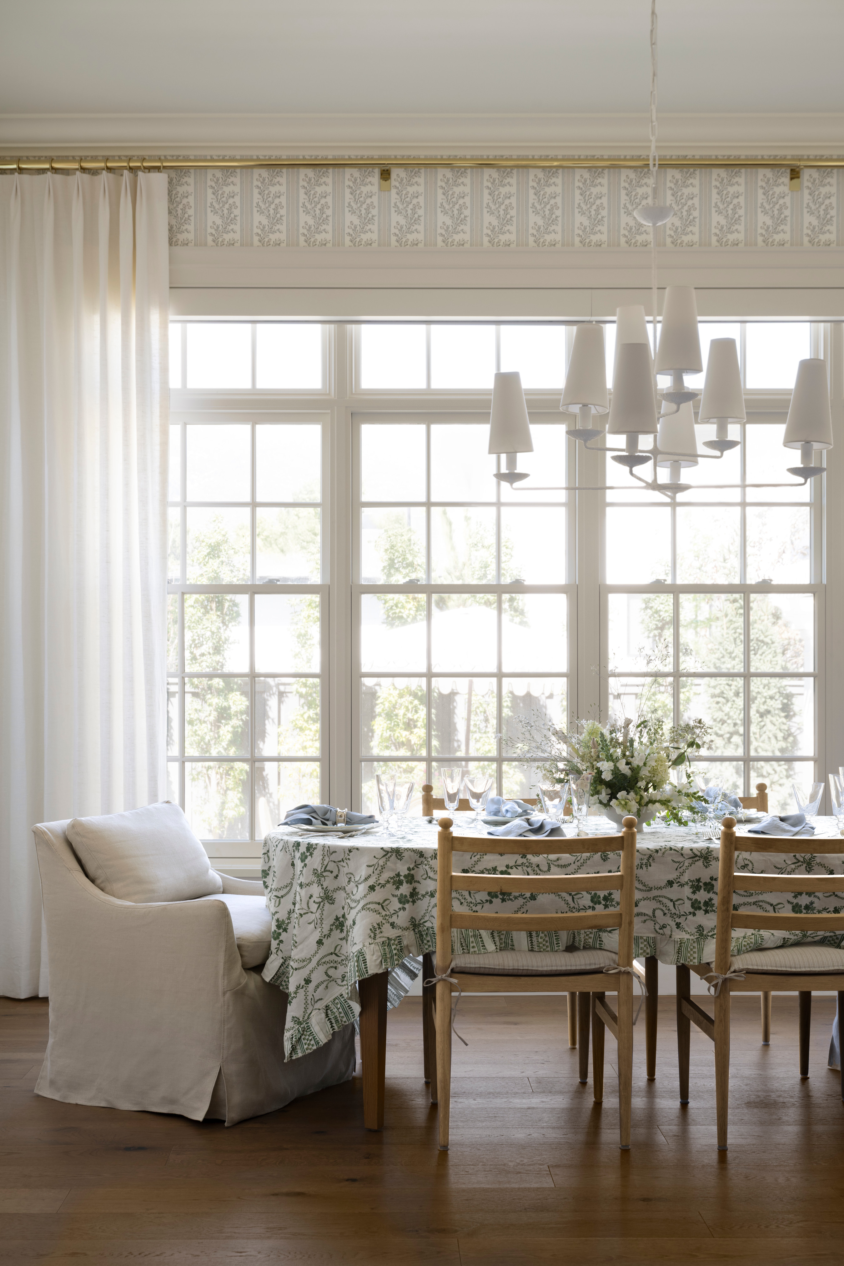A dining room with a table and chairs, by McGee & Co.