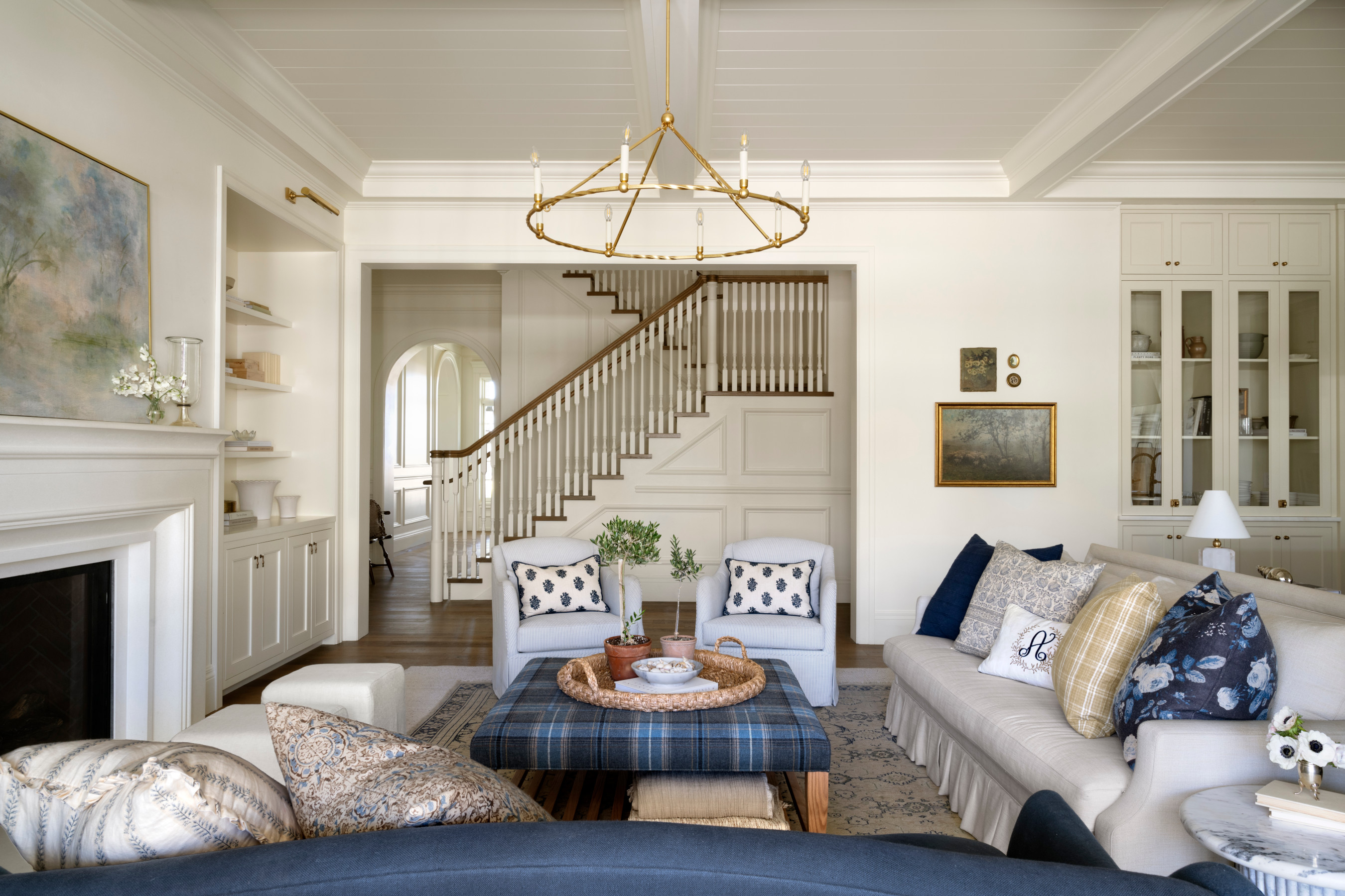 A living room with a chandelier, by McGee & Co.