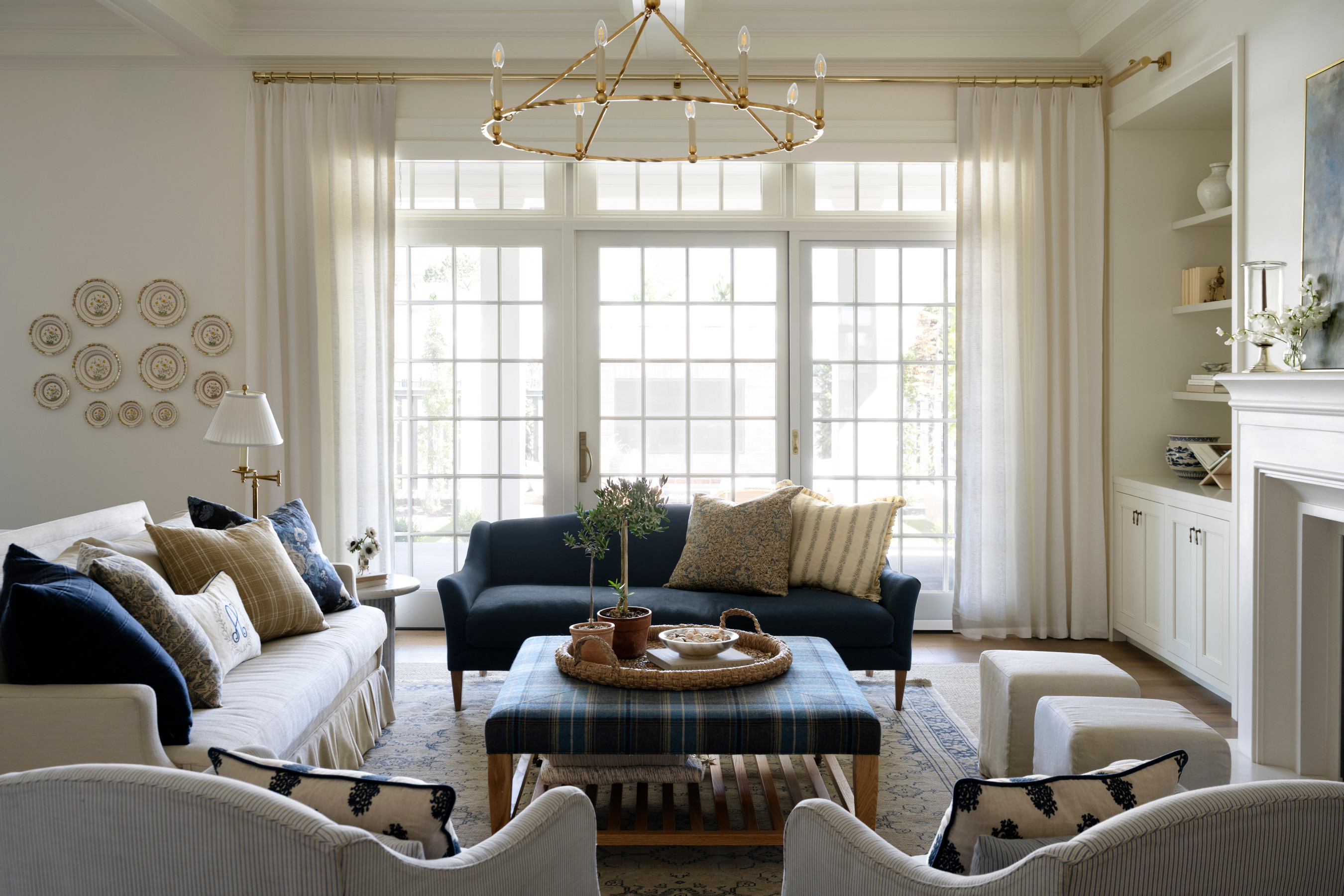 A living room with a couch and a coffee table, by McGee & Co.