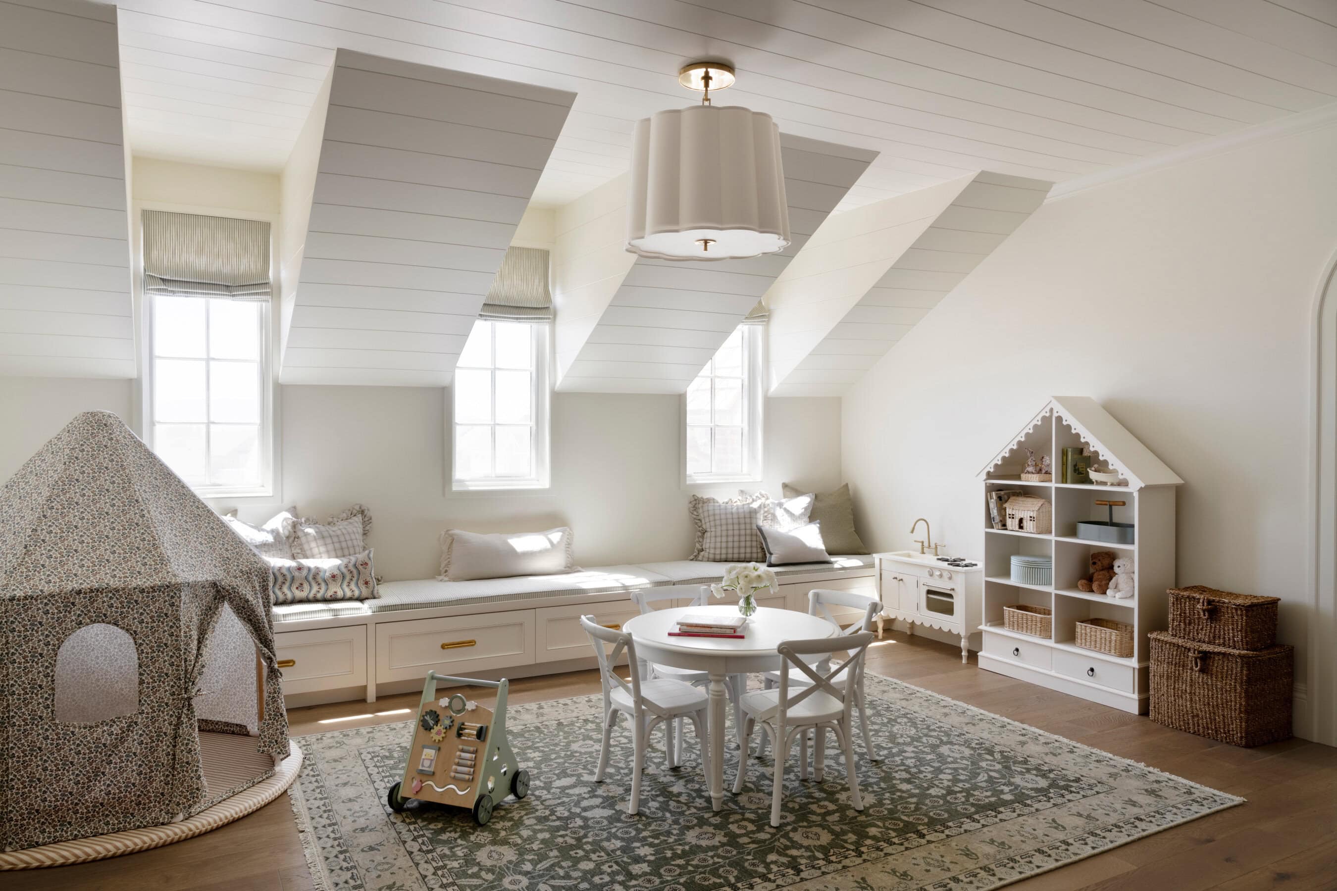 A room with a round table and a bench, by McGee & Co.