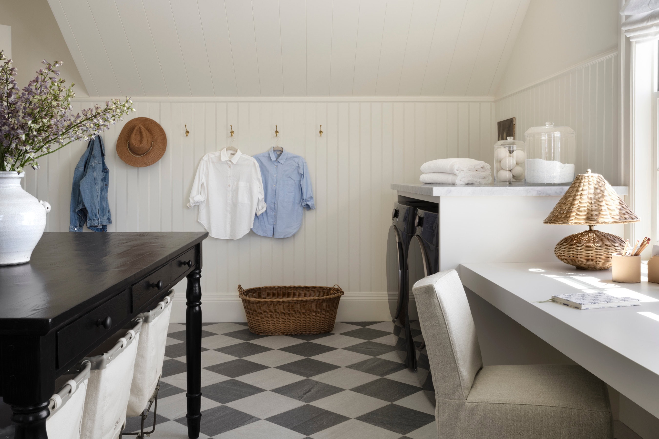A laundry room with a checkered floor and a basket, by McGee & Co.