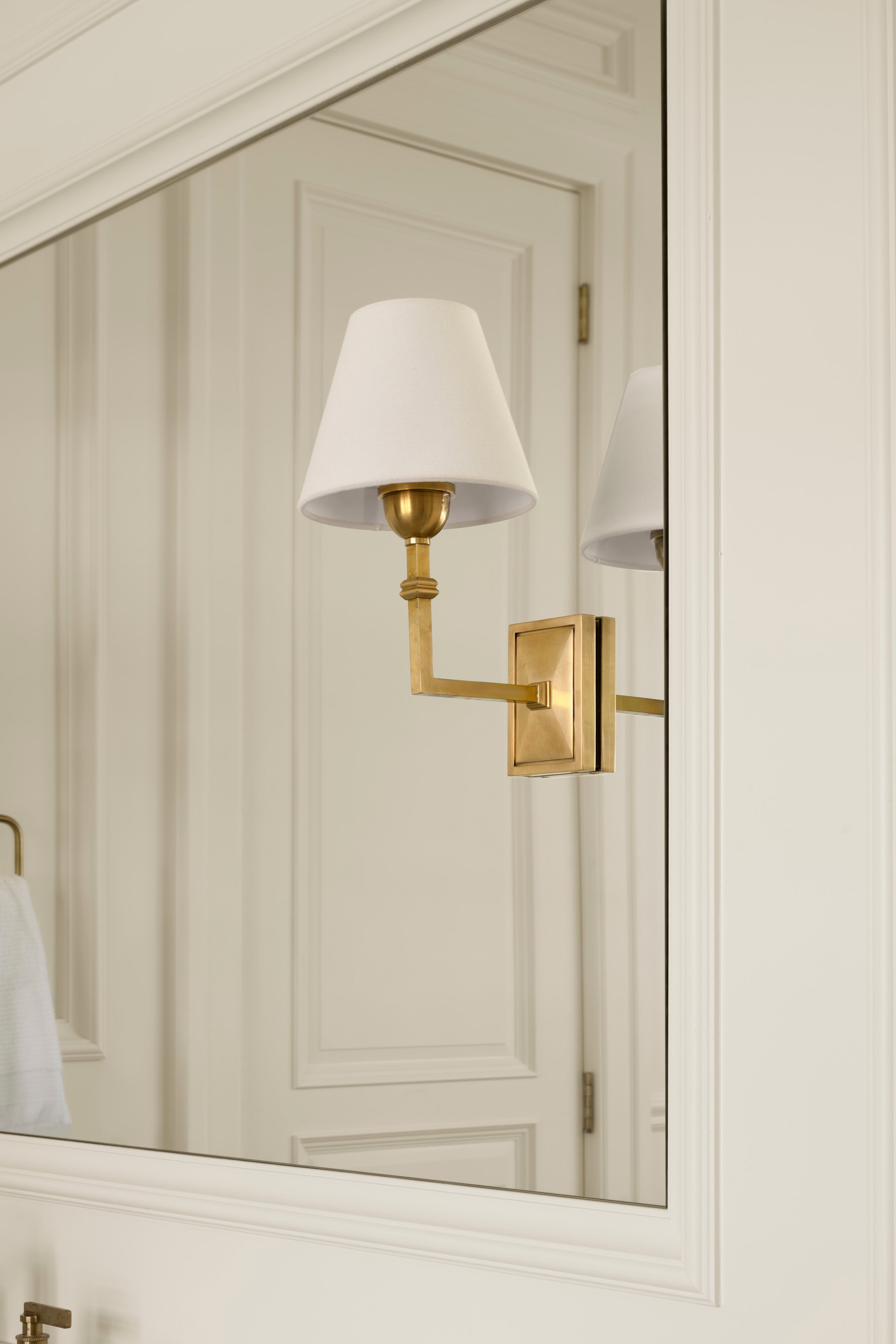 A mirror with a lamp on it, by McGee & Co.