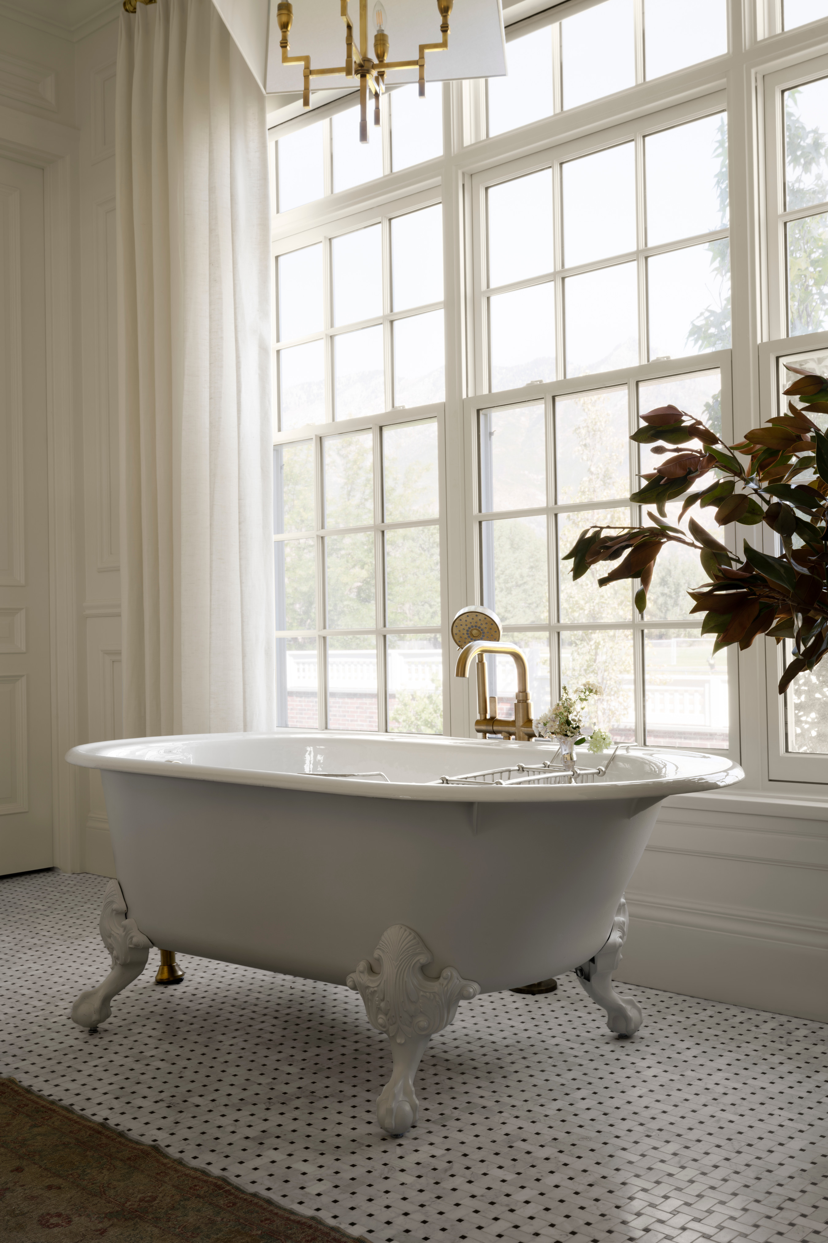 A white bathtub in a bathroom, by McGee & Co.