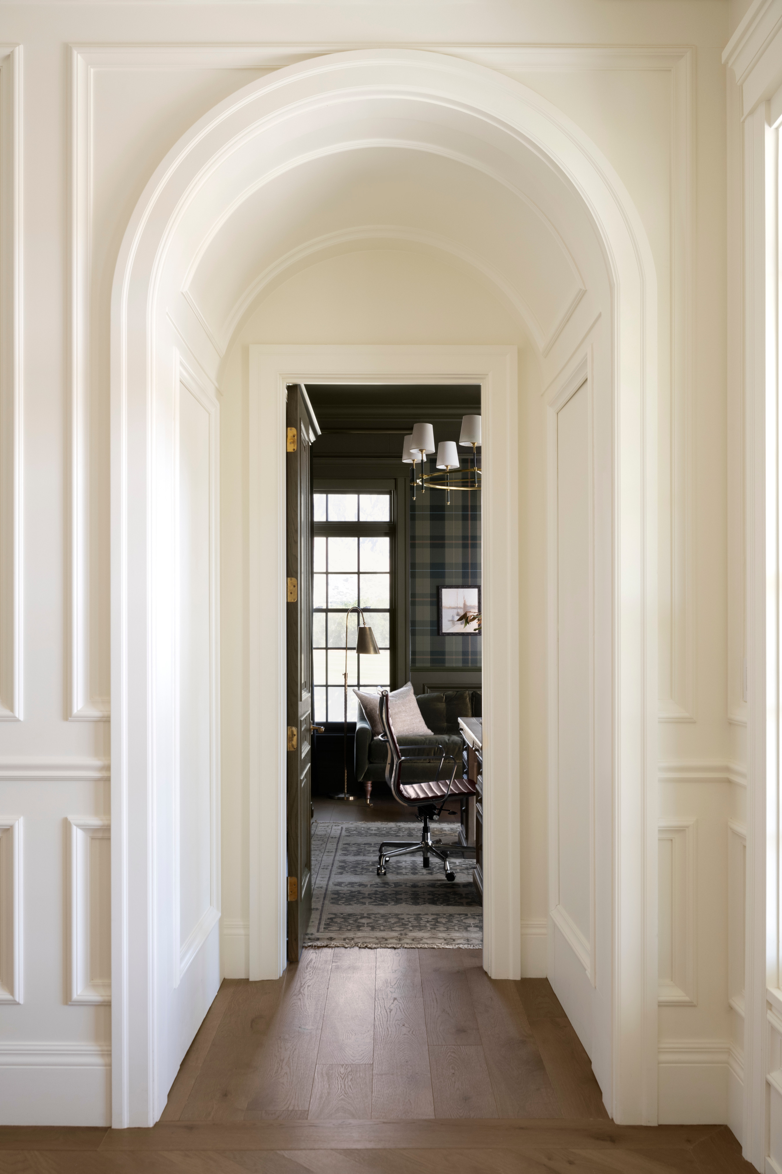 A hallway with a chair and a desk, by McGee & Co.