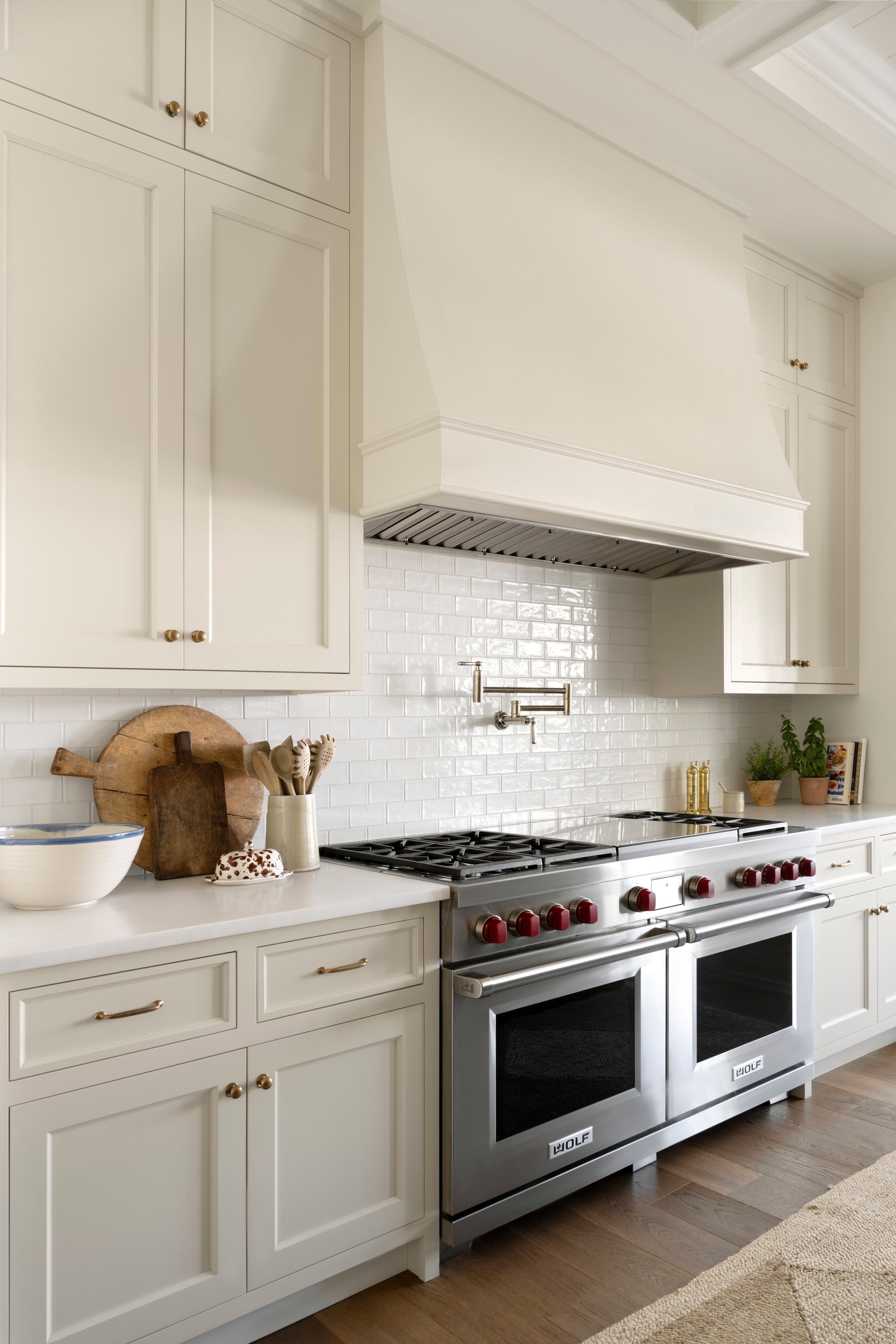 A kitchen with white cabinets and white appliances, by McGee & Co.