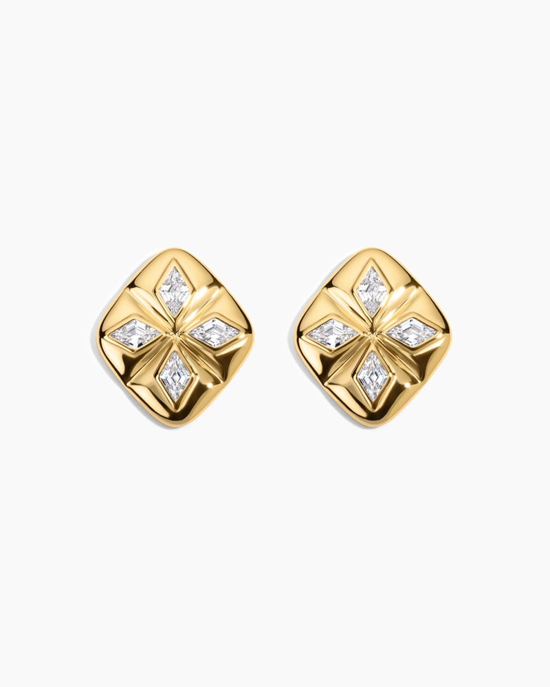 A pair of gold stud earrings, each featuring a raised four-point star design with small diamond accents set in the center of each petal, on a plain white background, by McGee & Co.