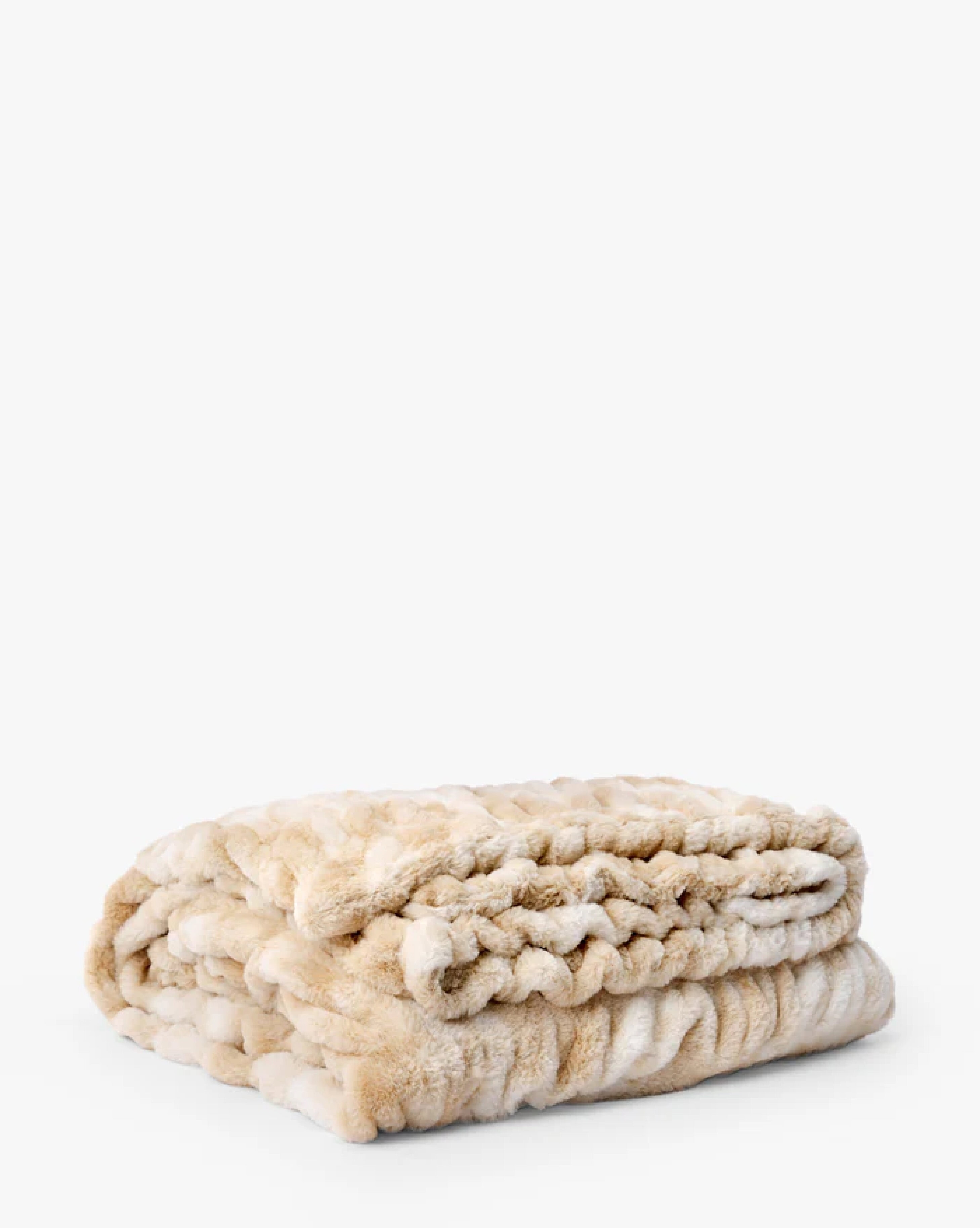 A thick, plush, light brown faux fur blanket folded neatly on a white background, by McGee & Co.